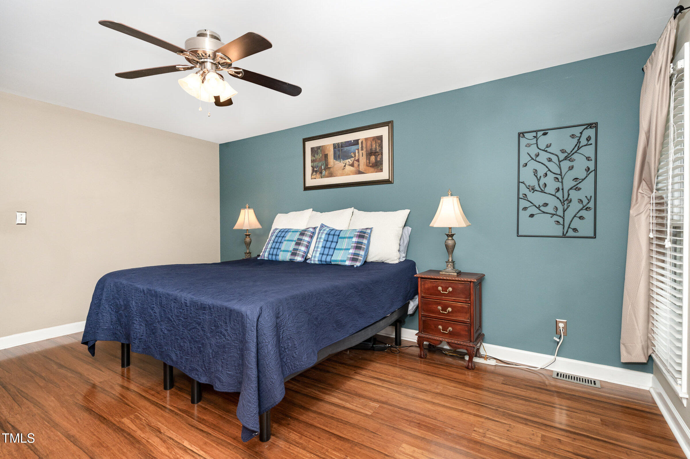 529 Ashebrook Drive Raleigh, NC 27609 - Photo 15 of 35 a bedroom with a bed and a chandelier