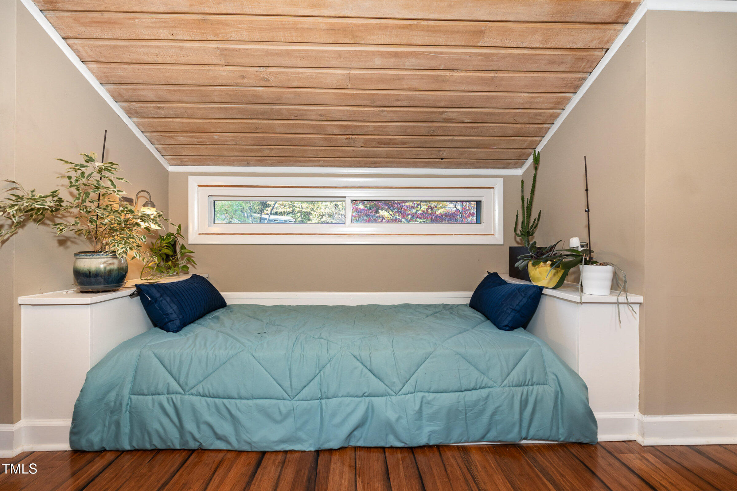 529 Ashebrook Drive Raleigh, NC 27609 - Photo 21 of 35 a bedroom with a bed and a potted plant