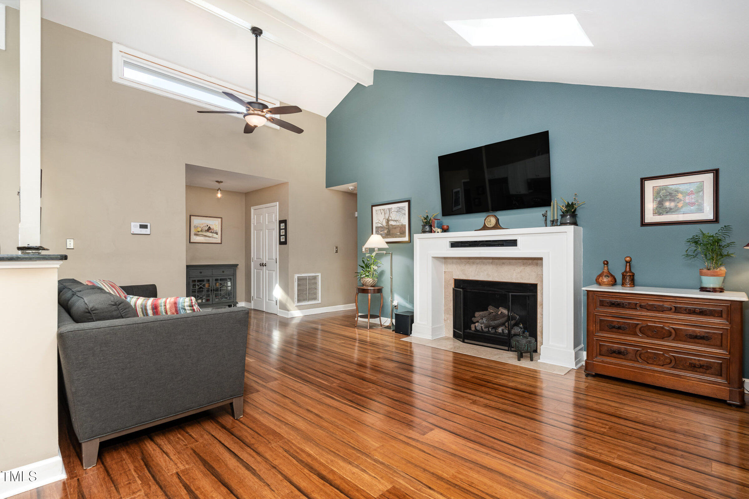 529 Ashebrook Drive Raleigh, NC 27609 - Photo 6 of 35 a living room with furniture a flat screen tv and a fireplace