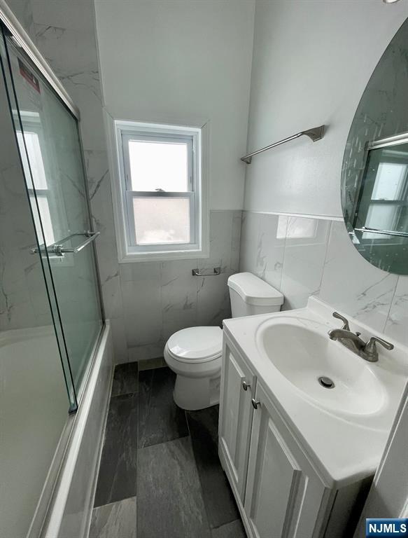 345 Kaplan Avenue, Unit 2 Hackensack, NJ 07601 - Photo 5 of 14 a bathroom with a sink and a mirror