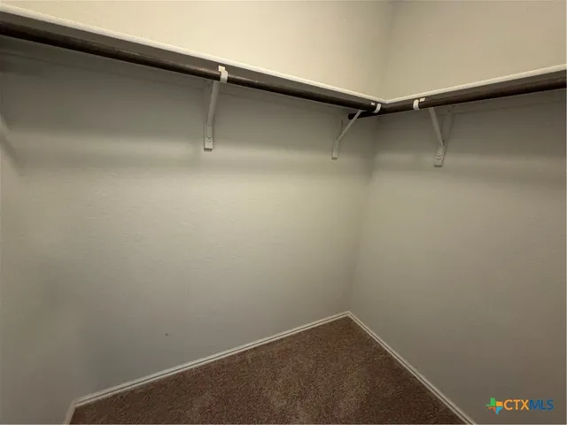 a view of a pathway with a garden