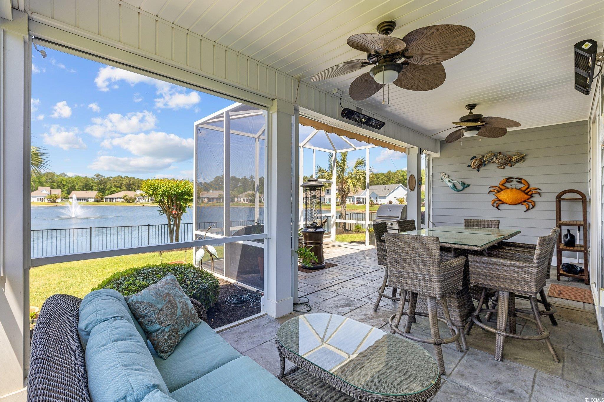 179 Hyacinth Loop Murrells Inlet, SC 29576 - Photo 28 of 40 View of patio featuring outdoor dining space, ceiling fan, a water view, an outdoor living space, and a lanai