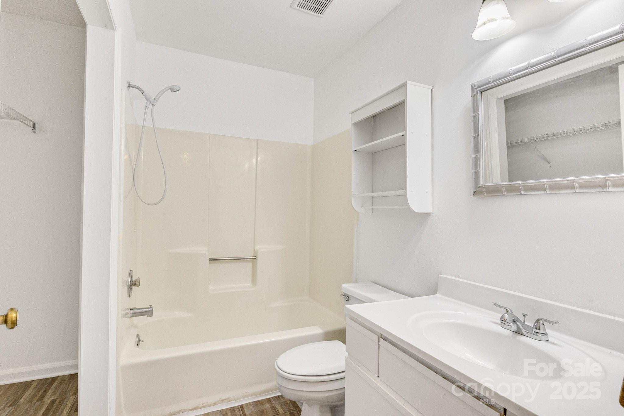 27097 Cove Lane Tega Cay, SC 29708 - Photo 12 of 30 a bathroom with a granite countertop sink toilet and shower