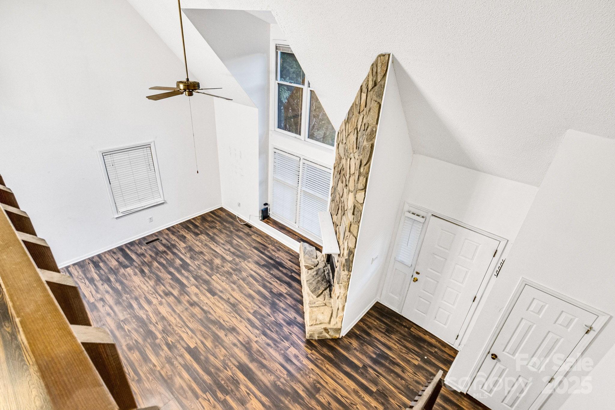 27097 Cove Lane Tega Cay, SC 29708 - Photo 18 of 30 a view of a bedroom with wooden floor and stairs