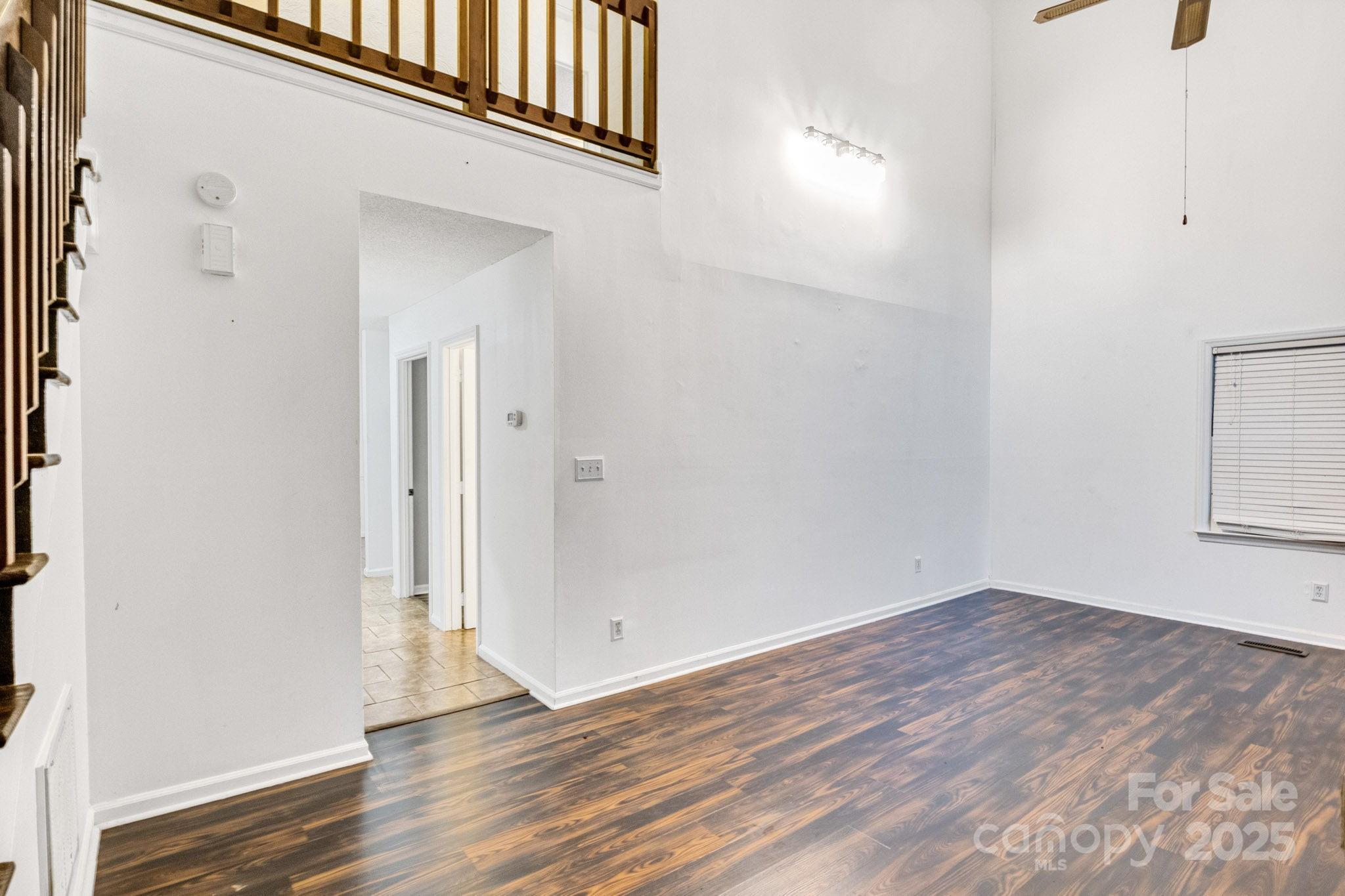 27097 Cove Lane Tega Cay, SC 29708 - Photo 19 of 30 an empty room with wooden floor and windows