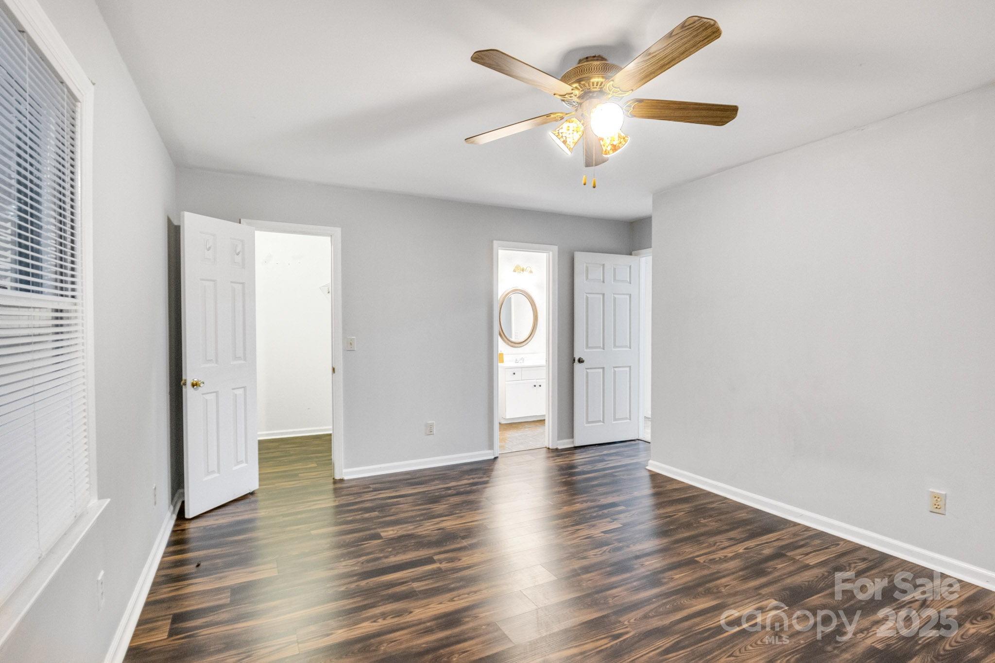 27097 Cove Lane Tega Cay, SC 29708 - Photo 23 of 30 an empty room with wooden floor and a ceiling fan