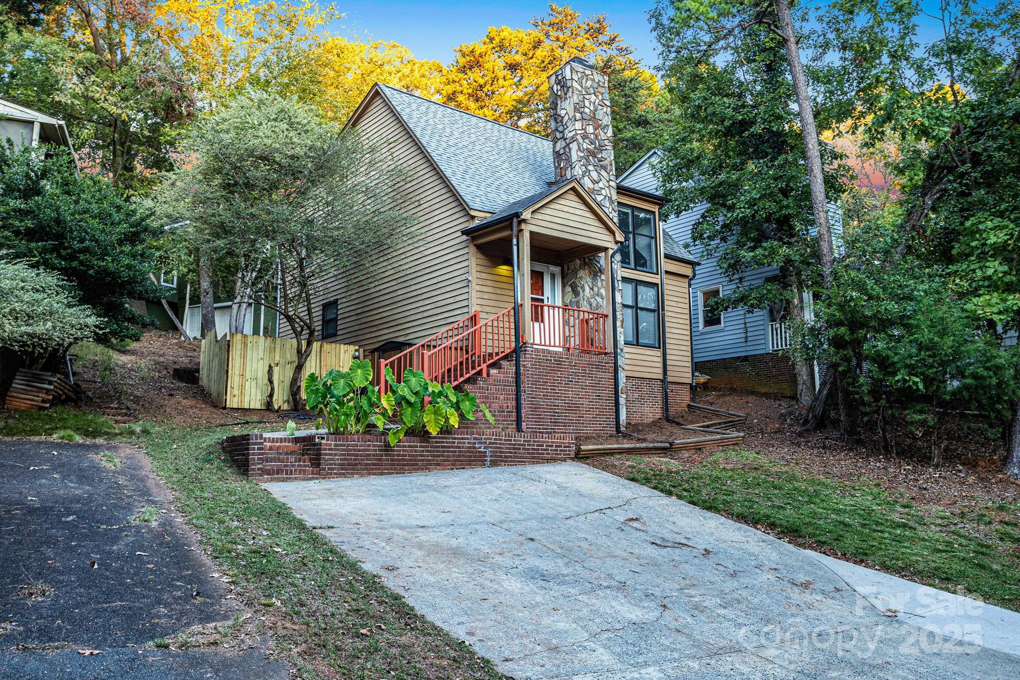 27097 Cove Lane Tega Cay, SC 29708 - Photo 5 of 30 a front view of a house with a yard and potted plants
