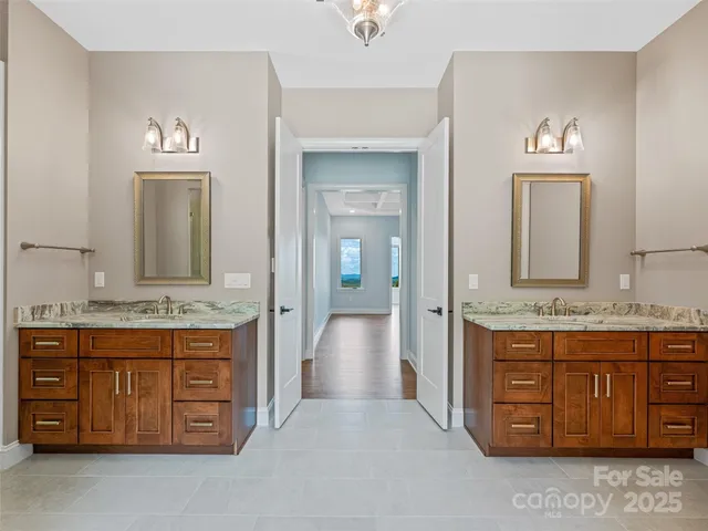 a spacious bathroom with a granite countertop sink and a mirror