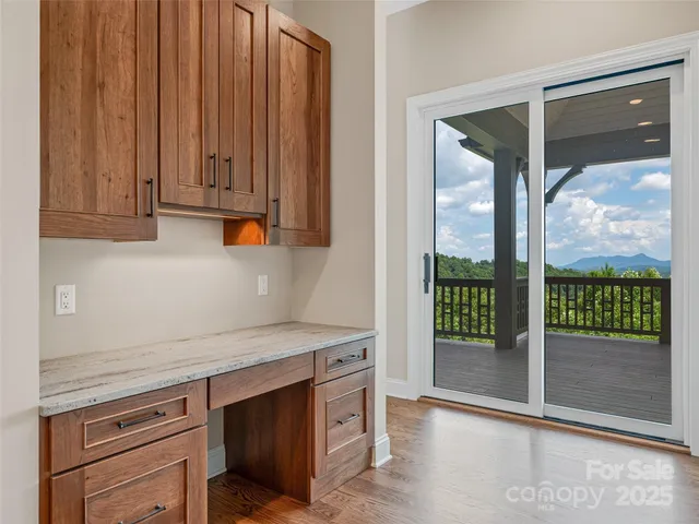 a kitchen with granite countertop a stove a sink and a granite counter tops with white cabinets