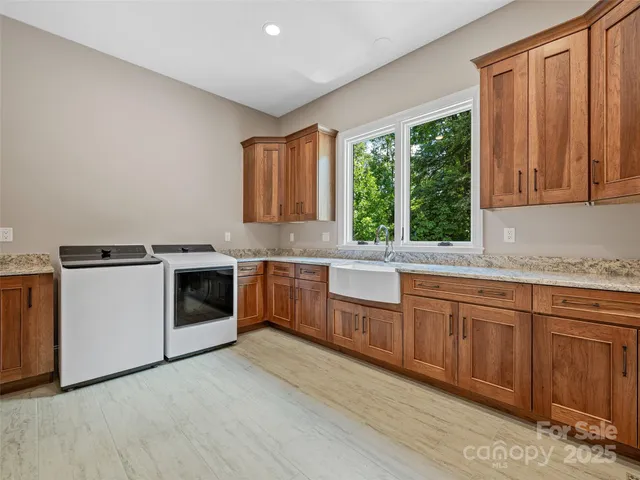 a kitchen with granite countertop white cabinets a sink and white stainless steel appliances