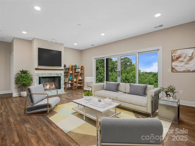 a living room with furniture a fireplace and a flat screen tv
