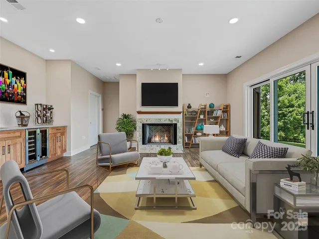 a living room with furniture a flat screen tv and a fireplace