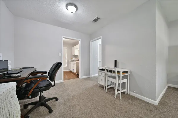a workspace with a table and chairs