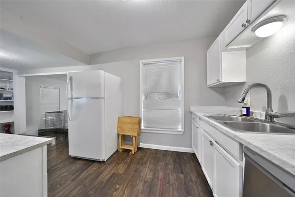 a kitchen with refrigerator and sink