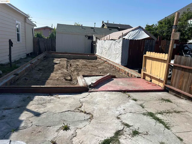 a view of a backyard with a small cabin and furniture