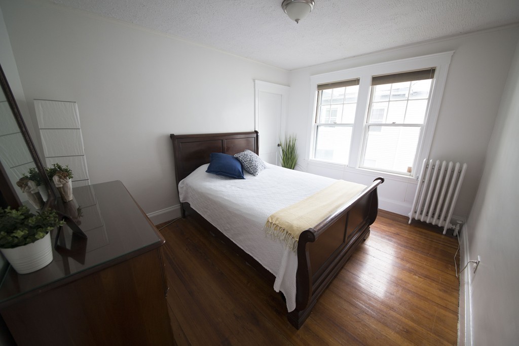 4 Nottingham Street, Unit 2 Newton, MA 02459 - Photo 11 of 18 a bedroom with a bed and a potted plant