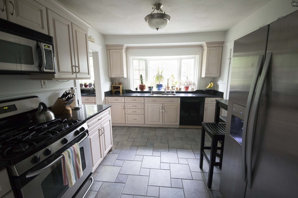 4 Nottingham Street, Unit 2 Newton, MA 02459 - Photo 6 of 18 a kitchen with stainless steel appliances granite countertop a sink stove refrigerator and cabinets