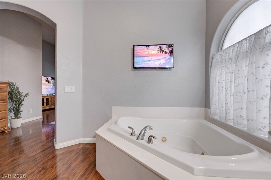 1604 Cattle Ranch Place Henderson, NV 89002 - Photo 43 of 99 Relax in this inviting soaking tub, perfectly situated for peaceful moments with soft lighting.