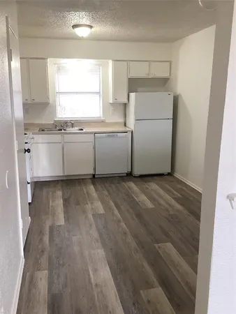 a kitchen with a refrigerator and a sink