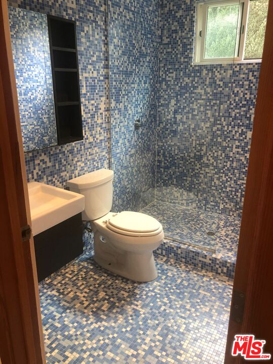 128 South Carson Road Beverly Hills, CA 90211 - Photo 11 of 20 a bathroom with a toilet and a shower