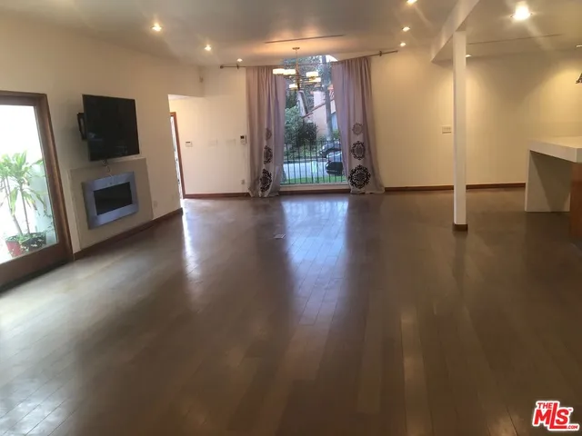a view of a kitchen with a sink and a fireplace