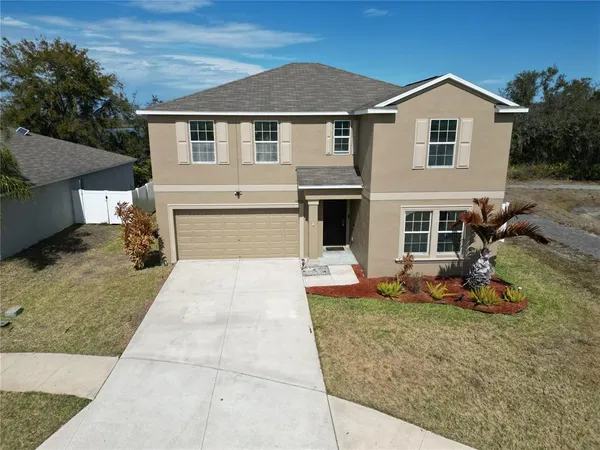 an aerial view of a house with outdoor space and lake view