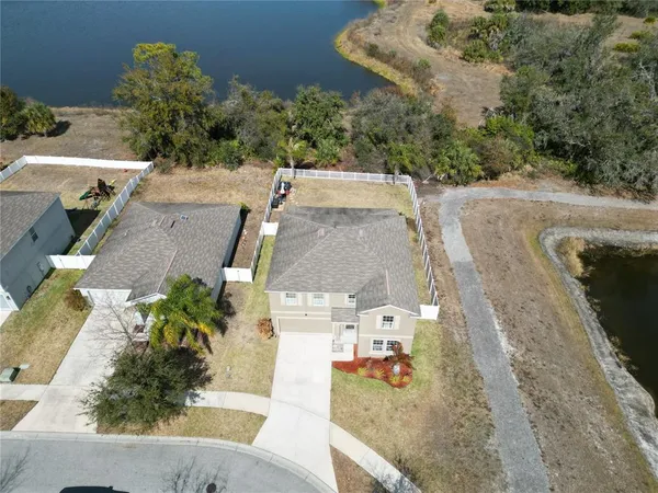 an aerial view of a house with a yard