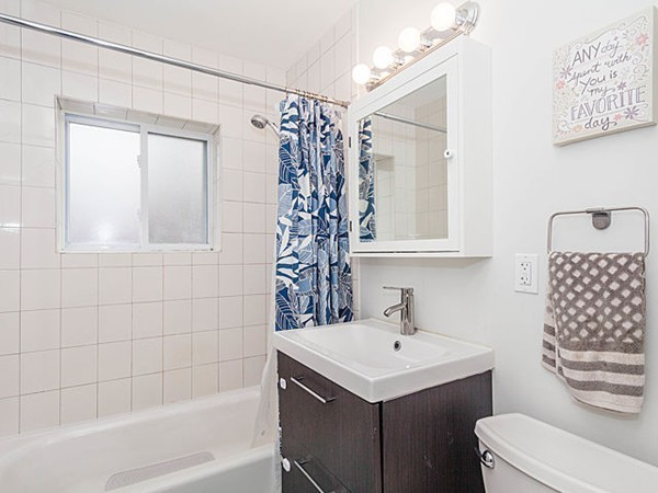39 Westgate Road, Unit 6 Boston, MA 02467 - Photo 5 of 8 a bathroom with a sink a toilet and shower