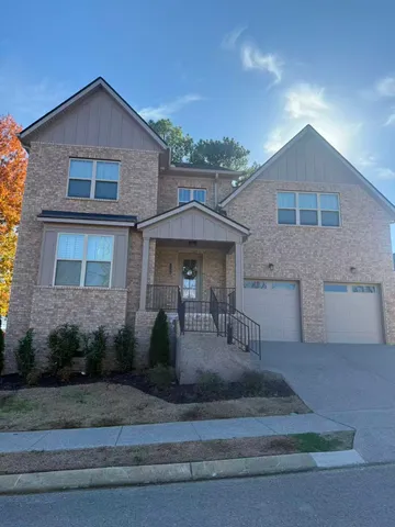 a front view of a house with garage