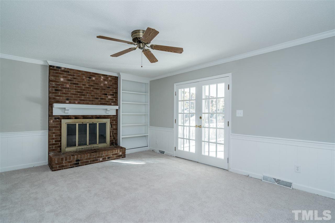 7212 St Ledger Drive Raleigh, NC 27613 - Photo 7 of 27 a view of an empty room with a fireplace and a window