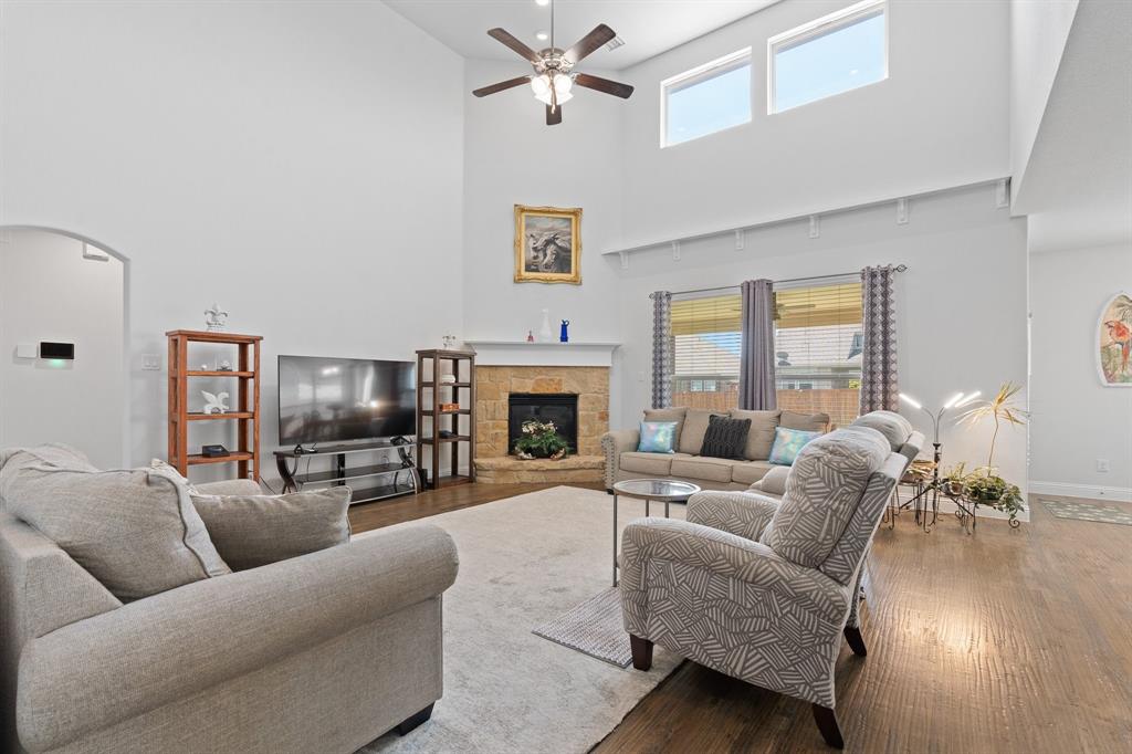 15105 Fleet Hill Road Aledo, TX 76008 - Photo 1 of 31 a living room with furniture a fireplace and a flat screen tv