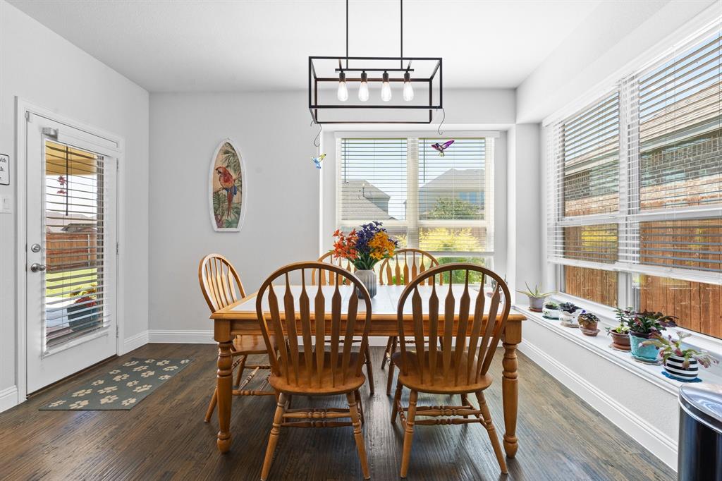 15105 Fleet Hill Road Aledo, TX 76008 - Photo 13 of 31 a dining room with furniture a chandelier and wooden floor