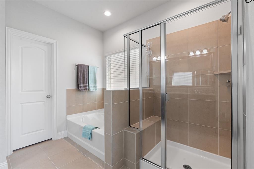 15105 Fleet Hill Road Aledo, TX 76008 - Photo 18 of 31 a bathroom with a glass shower door