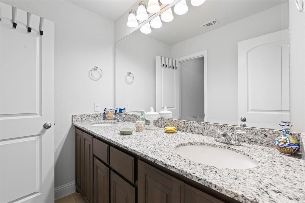15105 Fleet Hill Road Aledo, TX 76008 - Photo 24 of 31 a bathroom with a granite countertop double vanity sink and a mirror
