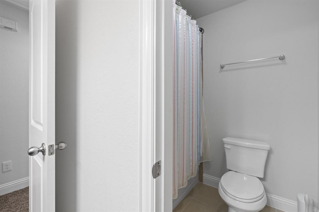 15105 Fleet Hill Road Aledo, TX 76008 - Photo 25 of 31 a white toilet sitting next to a shower