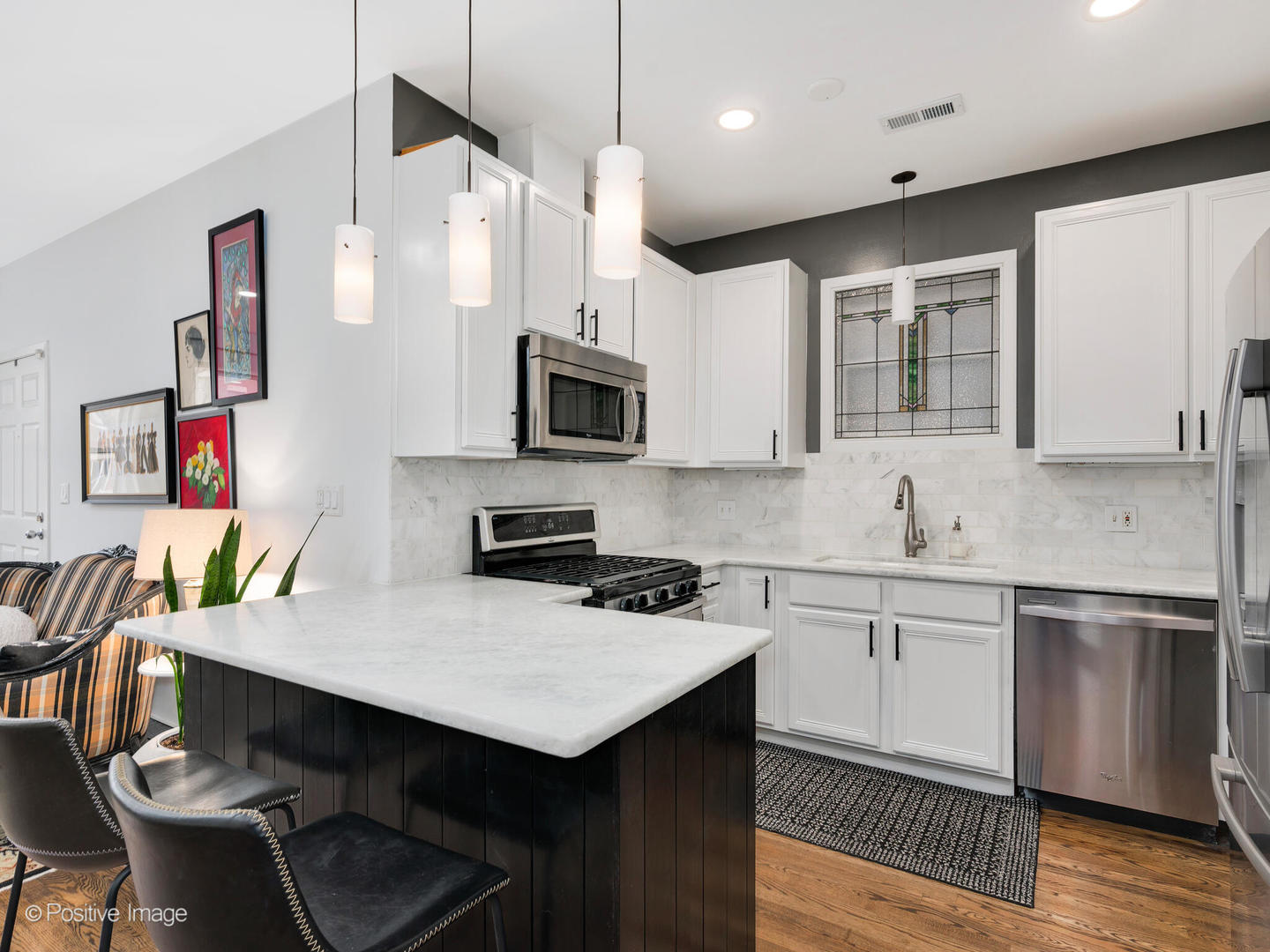 1349 West Fillmore Street, Unit B Chicago, IL 60607 - Photo 8 of 19 a kitchen with stainless steel appliances a stove a sink a microwave a refrigerator and cabinets