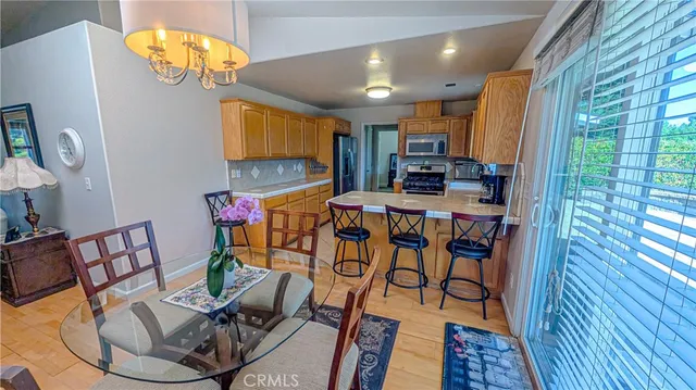 a kitchen with granite countertop stainless steel appliances white cabinets and a sink