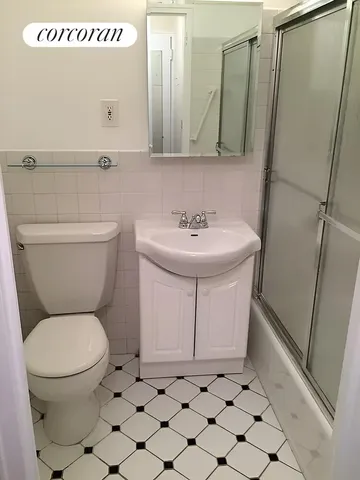 a bathroom with a toilet a sink and a mirror