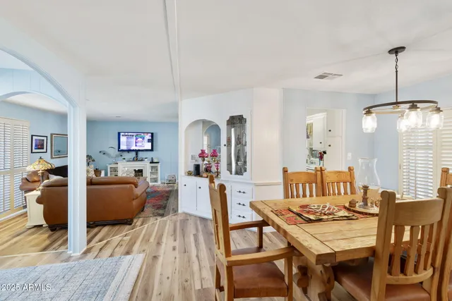 a dining room with furniture and wooden floor