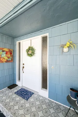 a bedroom with a bed and a painting on the wall