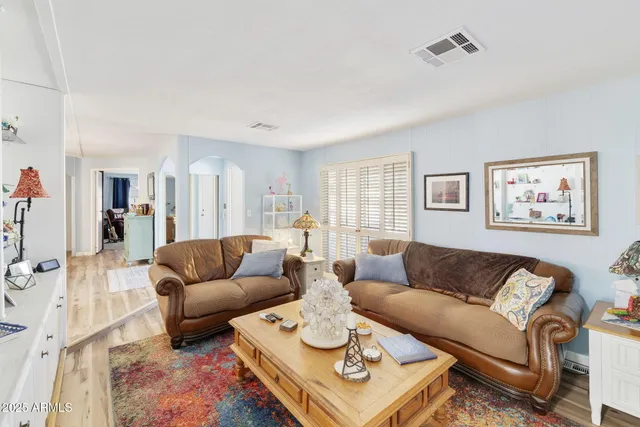 a living room with furniture a rug and a table