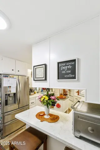 a dining room with stainless steel appliances a refrigerator and a stove