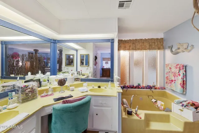 a bathroom with a tub sink and mirror