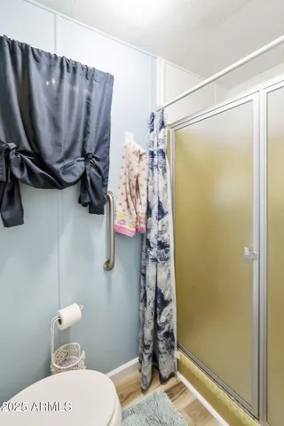 a bathroom with a toilet and a shower