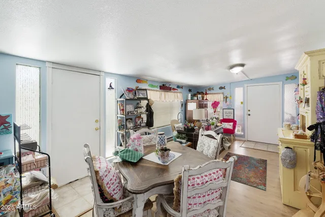 a view of a dining room with furniture and a kitchen