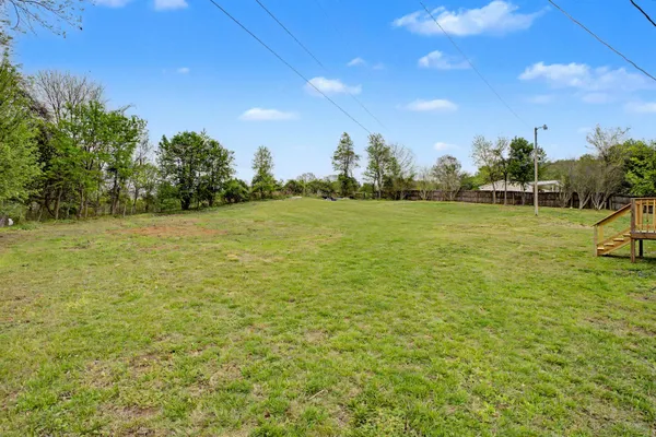 a view of a field with an trees in the background