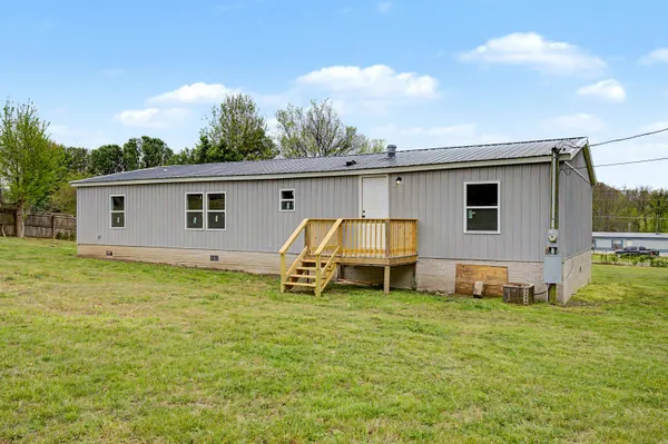 a backyard of a house with table and chairs