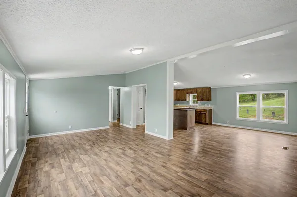 a view of a kitchen with a stove cabinets and wooden floor