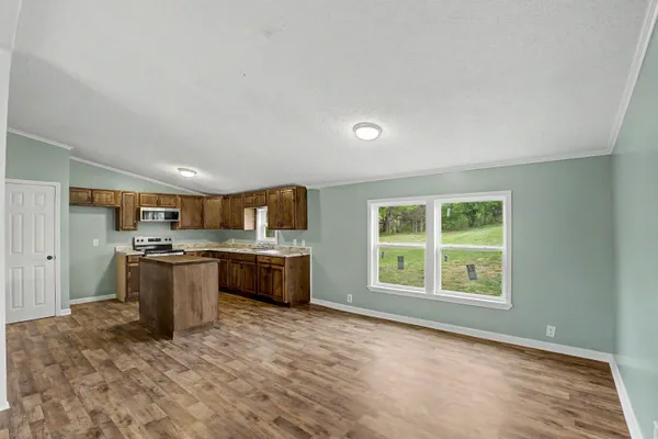 a large kitchen with a stove and a window