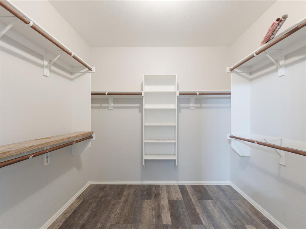 2009 Cooper Ridge Lane Heartland, TX 75126 - Photo 11 of 40 a view of walk in closet with empty racks